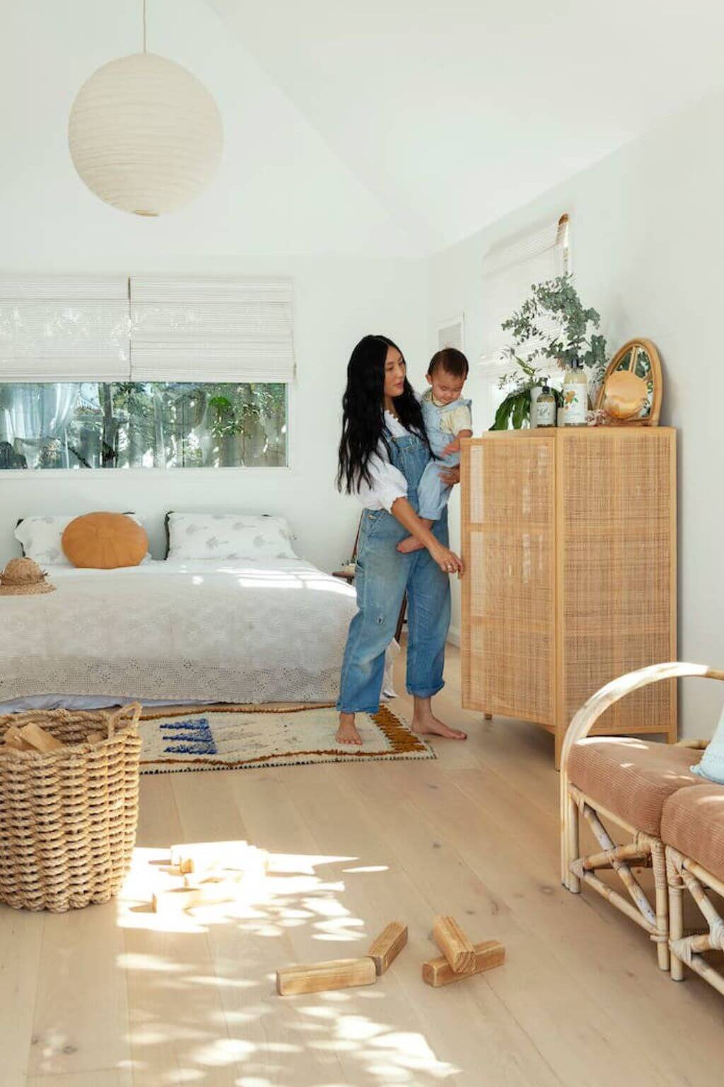 Woman and child in a bedroom with wooden furniture and decor