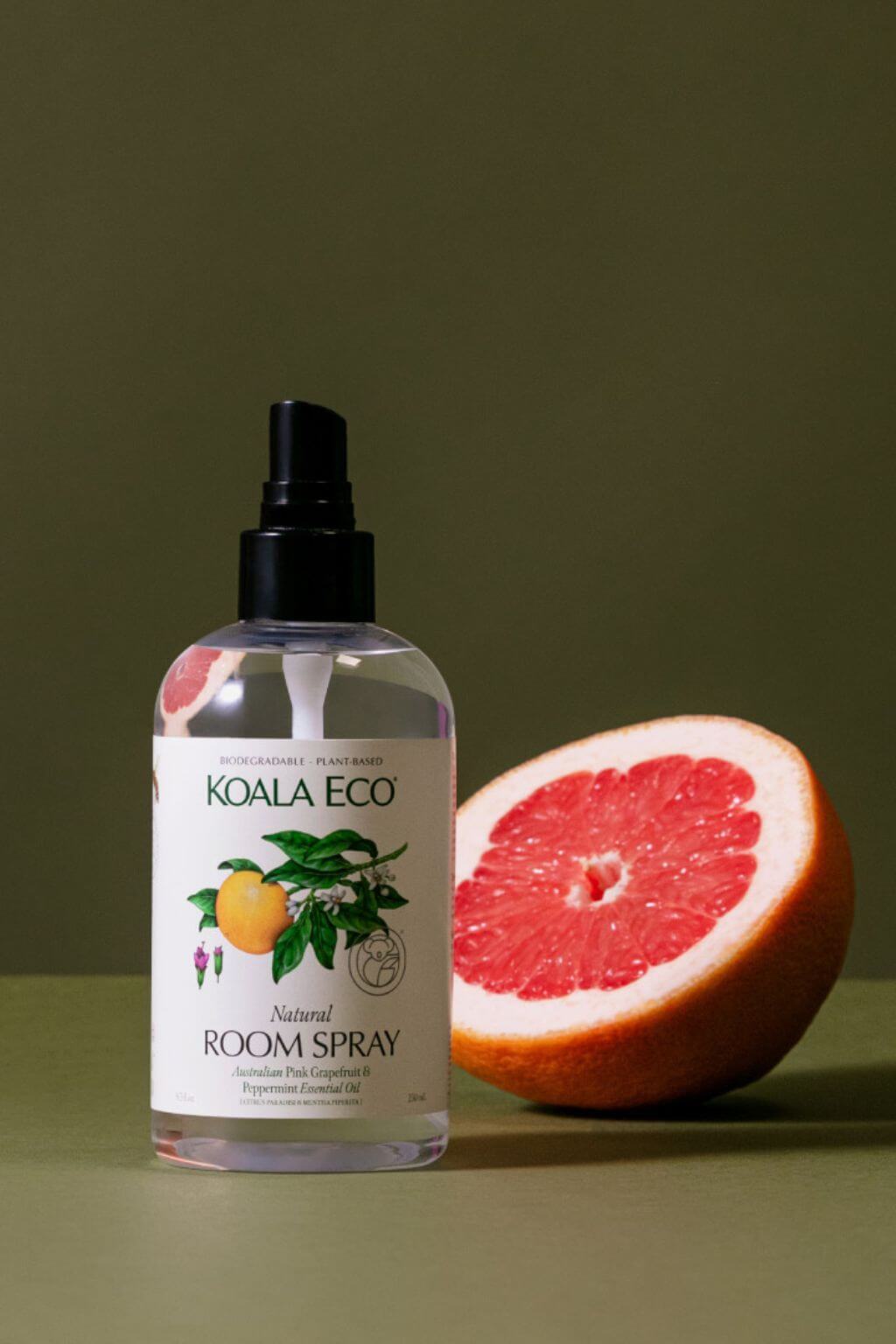 Koala Eco Natural Room Spray bottle with a half-grapefruit on a green background