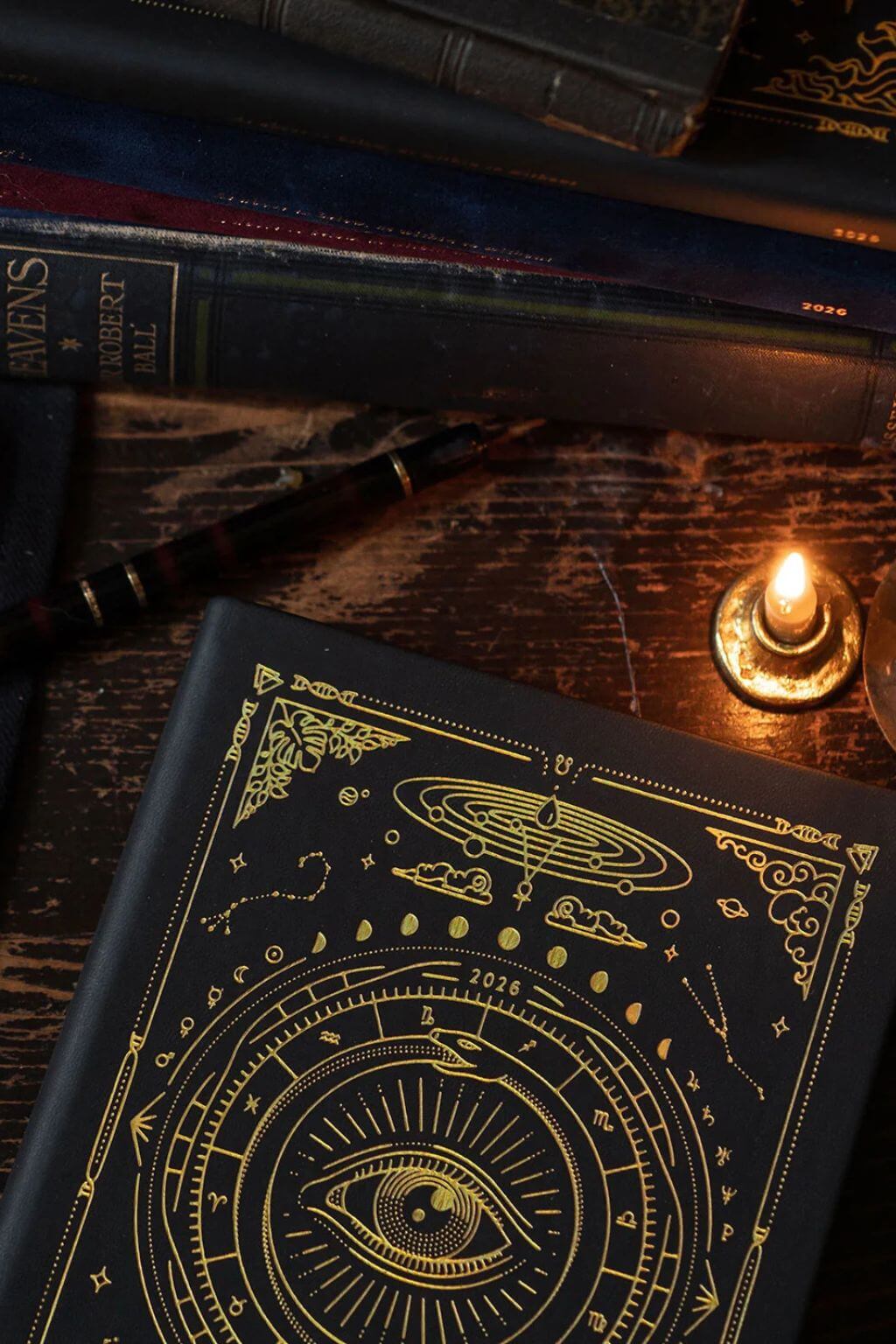 Magic of I 2026 Black Astrological Planner flat lay with pen, candle, and journal