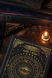 Magic of I 2026 Black Astrological Planner flat lay with pen, candle, and journal