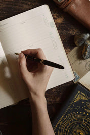 Magic of I 2026 Black planner styled with leather pouch and astrological tools