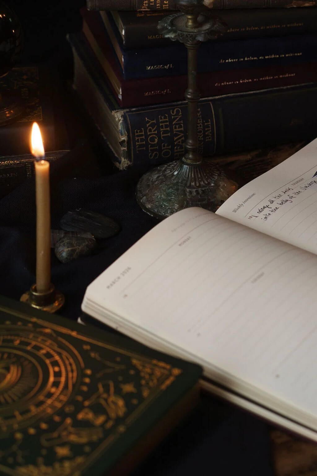 Magic of I 2026 Astrological Planner styled with candle, books, and journal ritual setting