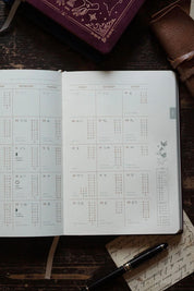 Magic of I planner interior showing March 2026 moon phases and astrological transits