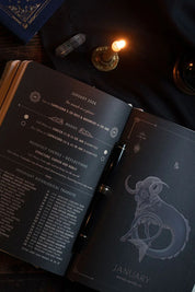 Open planner showing astrological themes and planetary transits for the month