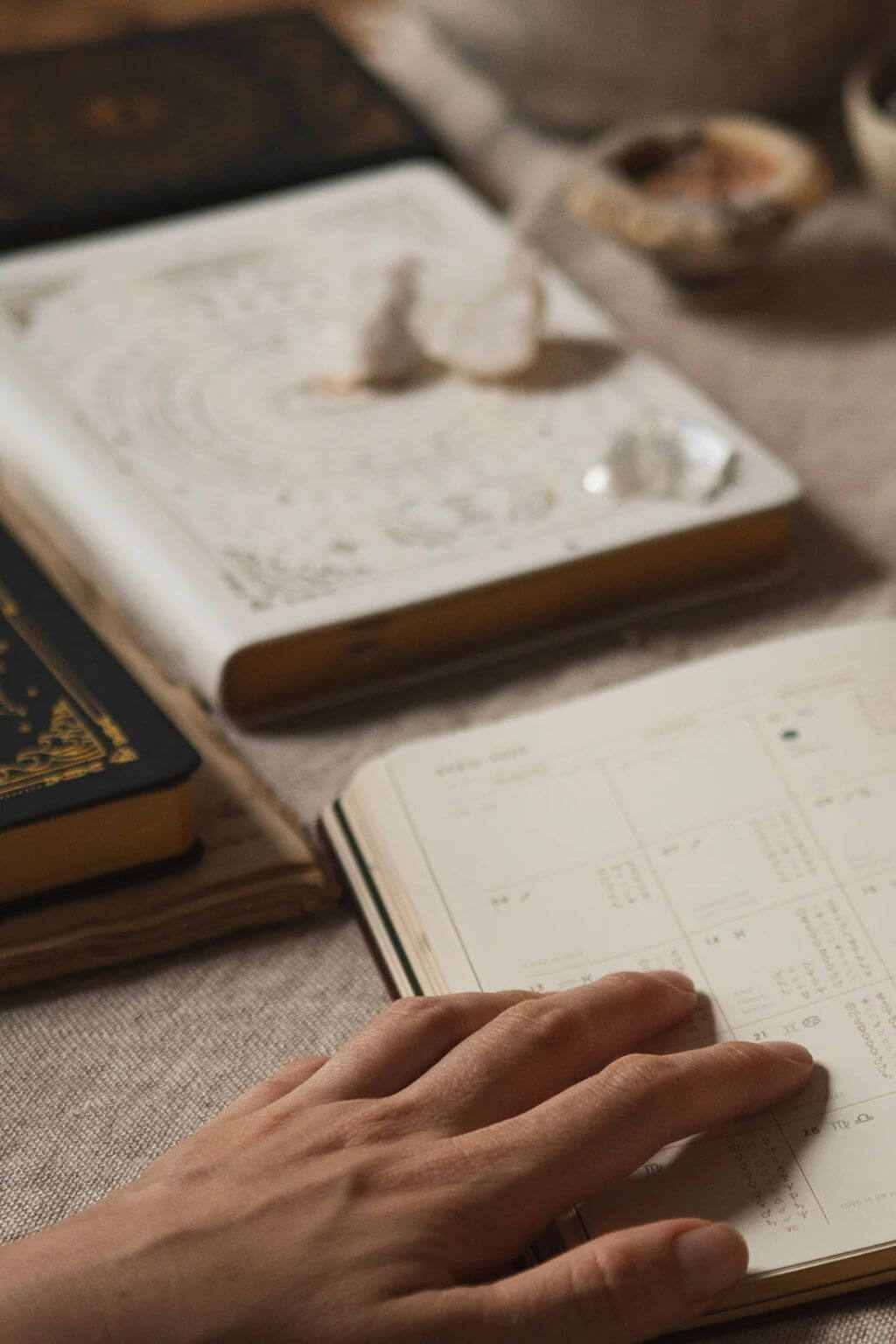 White Magic of I planner styled with crystals, books, and soft neutral textures