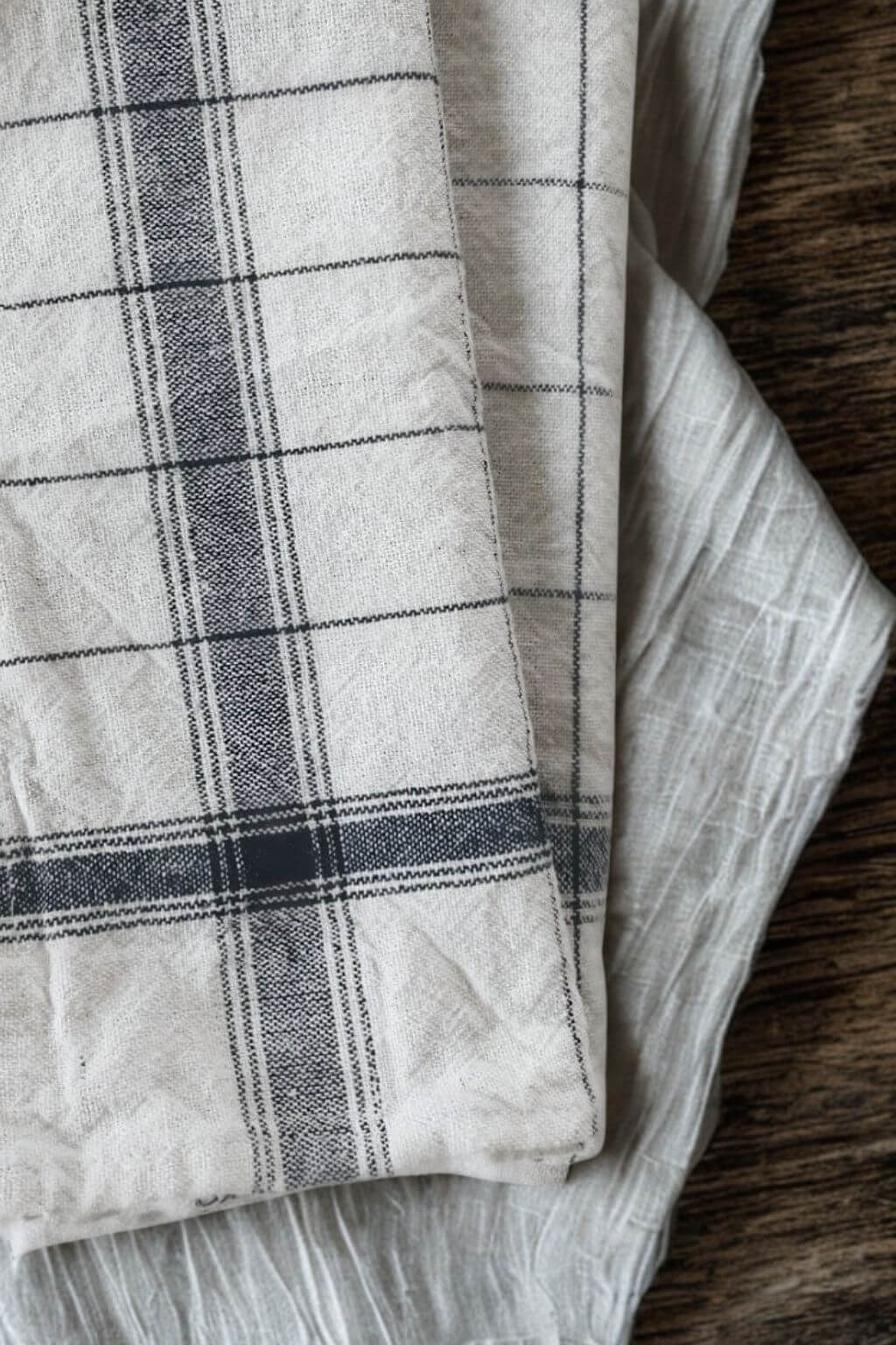 Close-up detail of navy handloom linen-cotton kitchen towel showing artisanal weave texture.