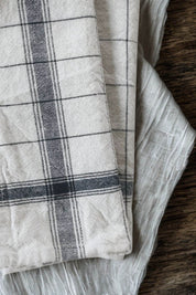Close-up detail of navy handloom linen-cotton kitchen towel showing artisanal weave texture.