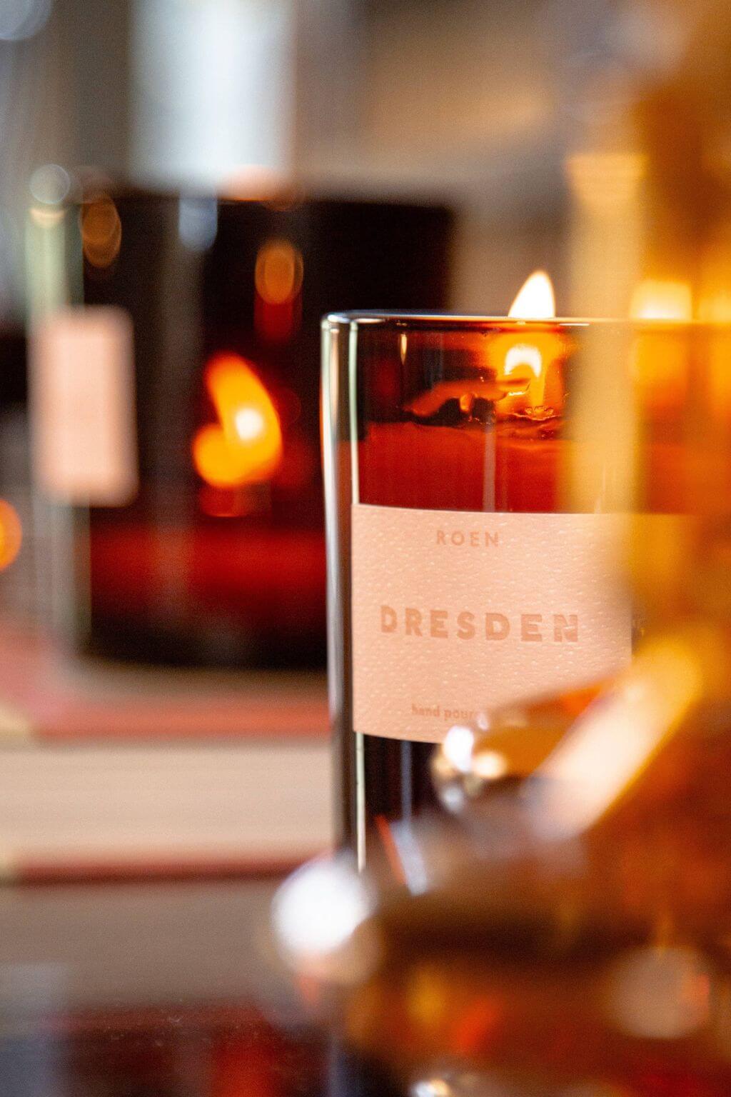 Close-up of Dresden candle flame in amber glass vessel