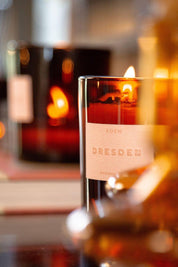 Close-up of Dresden candle flame in amber glass vessel