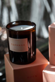 Topanga candle on stacked boxes with soft shadows