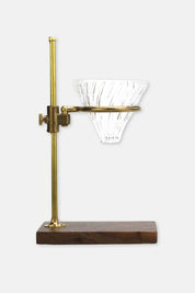 Side view of The Clerk Pour Over Stand showing brass structure and walnut base.