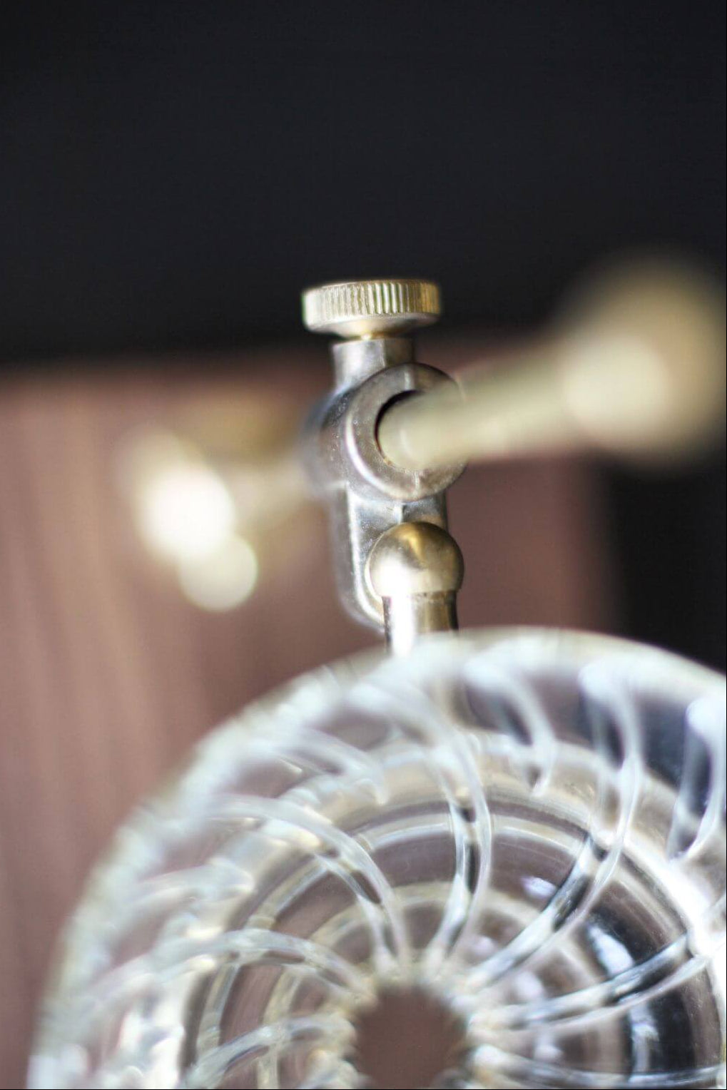 Detail of brass tightening knob and glass dripper connection.