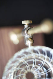 Detail of brass tightening knob and glass dripper connection.