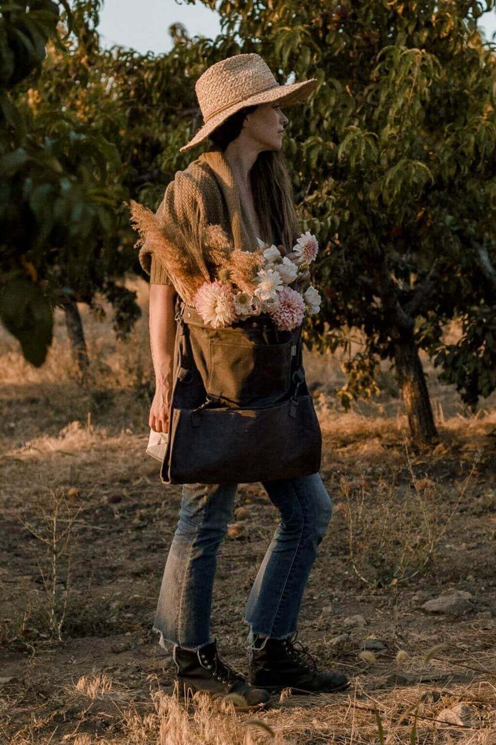 Dark khaki waxed canvas foraging bag filled with flowers